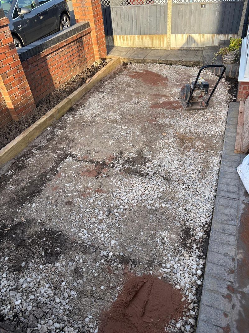 Stone sub-base being compacted with a plate compactor